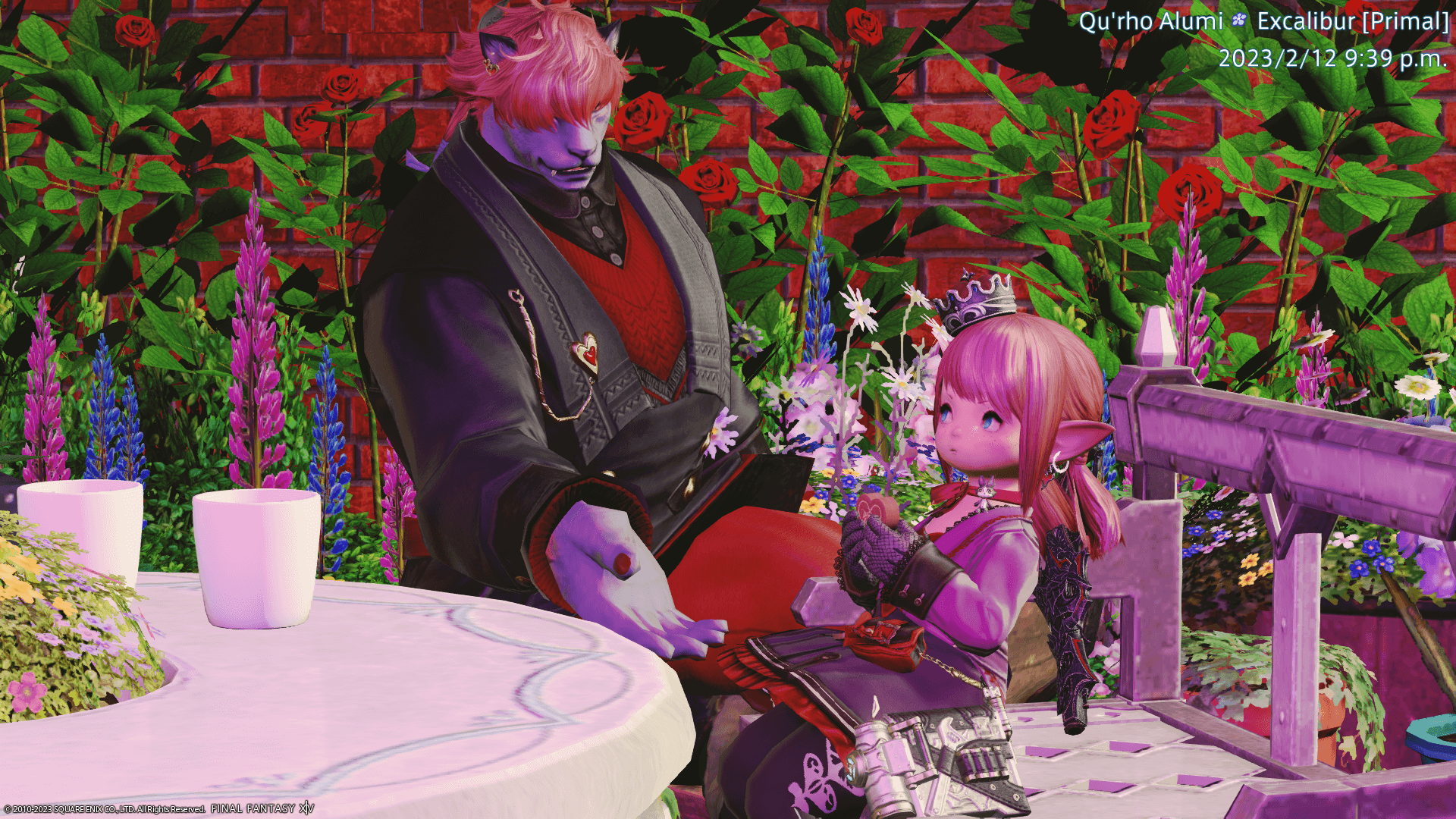 A screenshot with pink lighting. It features a hrothgar and a lalafell sitting outside, surrounded by plants. The hrothgar holds out their hand to the lalafell sitting on the bench, who is eating a large chocolate heart with a cute pout.